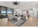 Open concept living area featuring a large sectional and kitchen views at 9020 Artisan Way, Sarasota, FL 34240