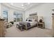 Relaxing main bedroom with water views and a comfortable sitting area at 9020 Artisan Way, Sarasota, FL 34240
