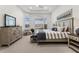 Spacious main bedroom with large windows and a sitting area at 9020 Artisan Way, Sarasota, FL 34240