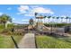 Community playground with playset and safety fencing at 9020 Artisan Way, Sarasota, FL 34240