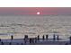 Beach sunset with people watching the sun set over the ocean at 919 Waterside Ln, Bradenton, FL 34209