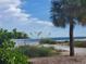 Scenic beach view with palm trees and clear sky at 919 Waterside Ln, Bradenton, FL 34209