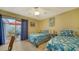 Bright guest bedroom with twin beds and patio access at 919 Waterside Ln, Bradenton, FL 34209