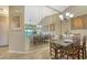 Dining area reflected in a large mirror, showing a view of the living area and balcony at 919 Waterside Ln, Bradenton, FL 34209