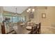 Dining area with table set for four, adjacent to living space and balcony at 919 Waterside Ln, Bradenton, FL 34209