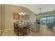 Bright dining area with table and chairs, offering access to living room and balcony at 919 Waterside Ln, Bradenton, FL 34209