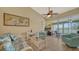 Living room with comfy seating, a ceiling fan, and access to a relaxing balcony at 919 Waterside Ln, Bradenton, FL 34209