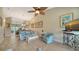 Living room with a sofa, chair, and view into the dining area and balcony at 919 Waterside Ln, Bradenton, FL 34209