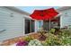 Relaxing patio with red umbrella, table, and chairs at 919 Waterside Ln, Bradenton, FL 34209