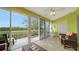 Sunroom with access to a balcony overlooking lush greenery at 919 Waterside Ln, Bradenton, FL 34209