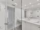 Spa-like bathroom with a double vanity, large mirror and glass enclosed shower at 100 Sands Point Rd # 323, Longboat Key, FL 34228