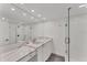 Clean bathroom featuring a double vanity, large mirror, and a walk-in shower at 100 Sands Point Rd # 323, Longboat Key, FL 34228