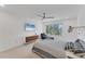 Comfortable bedroom with a queen bed, chaise lounge, and large window at 100 Sands Point Rd # 323, Longboat Key, FL 34228