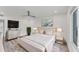 Elegant bedroom with a plush bed, large window, and a dresser at 100 Sands Point Rd # 323, Longboat Key, FL 34228