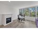 Bright home office with hardwood floors, large windows, and built in fireplace at 100 Sands Point Rd # 323, Longboat Key, FL 34228