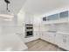 Bright kitchen featuring white cabinets, double oven, and quartz countertops at 100 Sands Point Rd # 323, Longboat Key, FL 34228