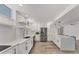 Modern white kitchen with stainless steel appliances and ample counter space at 100 Sands Point Rd # 323, Longboat Key, FL 34228