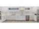 Modern white kitchen with stainless steel appliances and quartz countertops at 100 Sands Point Rd # 323, Longboat Key, FL 34228