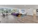 Modern living room with hardwood floors and views of lush landscaping at 100 Sands Point Rd # 323, Longboat Key, FL 34228