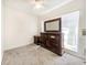 Bedroom with large window, dresser and carpet at 1003 Patterson Dr, Sarasota, FL 34234