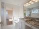 Bathroom with granite vanity, toilet and view into bedroom at 1178 Fraser Pine Blvd, Sarasota, FL 34240