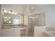 Elegant bathroom with granite countertops, a soaking tub, and a glass shower at 1178 Fraser Pine Blvd, Sarasota, FL 34240