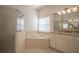 Bathroom with corner soaking tub, shower, and granite vanity at 1178 Fraser Pine Blvd, Sarasota, FL 34240