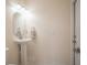 Simple pedestal sink in light-toned powder room at 1178 Fraser Pine Blvd, Sarasota, FL 34240