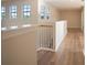 Spacious hallway with hardwood floors and multiple windows at 1178 Fraser Pine Blvd, Sarasota, FL 34240