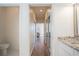 Long hallway with wood floors and mirrored closet doors at 1178 Fraser Pine Blvd, Sarasota, FL 34240