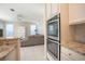 Bright kitchen features double oven and granite countertops at 1178 Fraser Pine Blvd, Sarasota, FL 34240