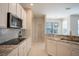Kitchen boasts granite countertops and modern appliances at 1178 Fraser Pine Blvd, Sarasota, FL 34240