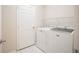 Bright laundry room, features washer, dryer, and shelving at 1178 Fraser Pine Blvd, Sarasota, FL 34240
