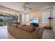 Relaxing living room with sliding glass doors and view at 1178 Fraser Pine Blvd, Sarasota, FL 34240