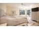 Spacious main bedroom with a king-size bed, built-in dresser, and home office at 1178 Fraser Pine Blvd, Sarasota, FL 34240