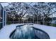 Screened pool at dusk, surrounded by lush trees at 1178 Fraser Pine Blvd, Sarasota, FL 34240