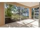 Peaceful screened porch with view of the garden at 1178 Fraser Pine Blvd, Sarasota, FL 34240