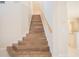 Elegant wooden staircase leading to the upper level at 1178 Fraser Pine Blvd, Sarasota, FL 34240