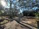 Long driveway leading to a charming house nestled among trees at 121 Christie Ave, Sarasota, FL 34232