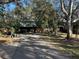 Home with driveway and a large yard at 121 Christie Ave, Sarasota, FL 34232