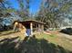 Single story home with a covered porch and yard at 121 Christie Ave, Sarasota, FL 34232