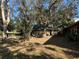 Ranch-style home with mature landscaping and a large yard at 121 Christie Ave, Sarasota, FL 34232