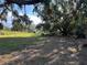 Vacant lot with grassy area and mature trees at 121 Christie Ave, Sarasota, FL 34232