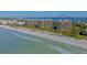 Aerial view of beachfront condo building with tennis courts and pool at 1211 Gulf Of Mexico Dr # 603, Longboat Key, FL 34228