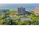 Aerial view of condo building near tennis courts and beach access at 1211 Gulf Of Mexico Dr # 603, Longboat Key, FL 34228