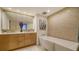 Elegant bathroom with a double vanity, a free-standing bathtub and a decorative tile feature wall at 1211 Gulf Of Mexico Dr # 603, Longboat Key, FL 34228
