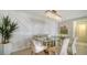 Elegant dining room with glass table and statement wall at 1211 Gulf Of Mexico Dr # 603, Longboat Key, FL 34228