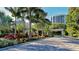 Gated entrance to the community with lush landscaping and palm trees at 1211 Gulf Of Mexico Dr # 603, Longboat Key, FL 34228