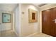 Condo entryway with wood door and decorative mirror at 1211 Gulf Of Mexico Dr # 603, Longboat Key, FL 34228