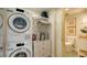 Laundry room with a stackable washer and dryer and additional storage at 1211 Gulf Of Mexico Dr # 603, Longboat Key, FL 34228